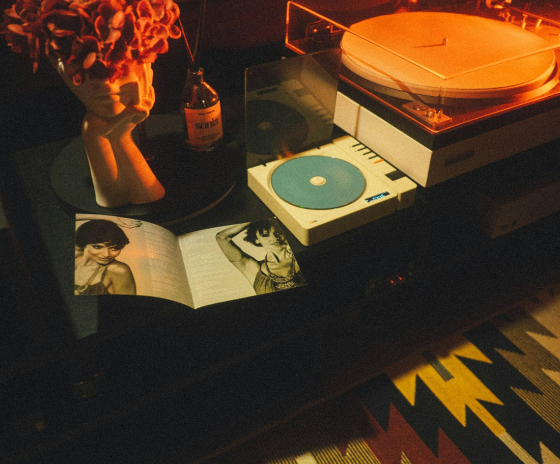 Vintage record player on a table with a retro magazine and warm lighting